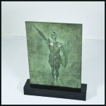Plaque by R. Delandre in cast iron showing athlete in relief doing the Olympic salute holding a palm branch inside of a stadium, 262mm tall